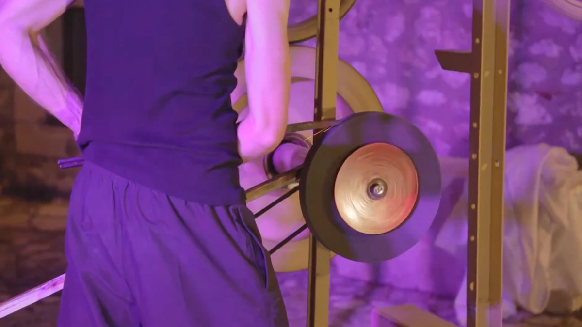 Professional videomaker demonstrating resistance training equipment with precise mechanics and ergonomic design.